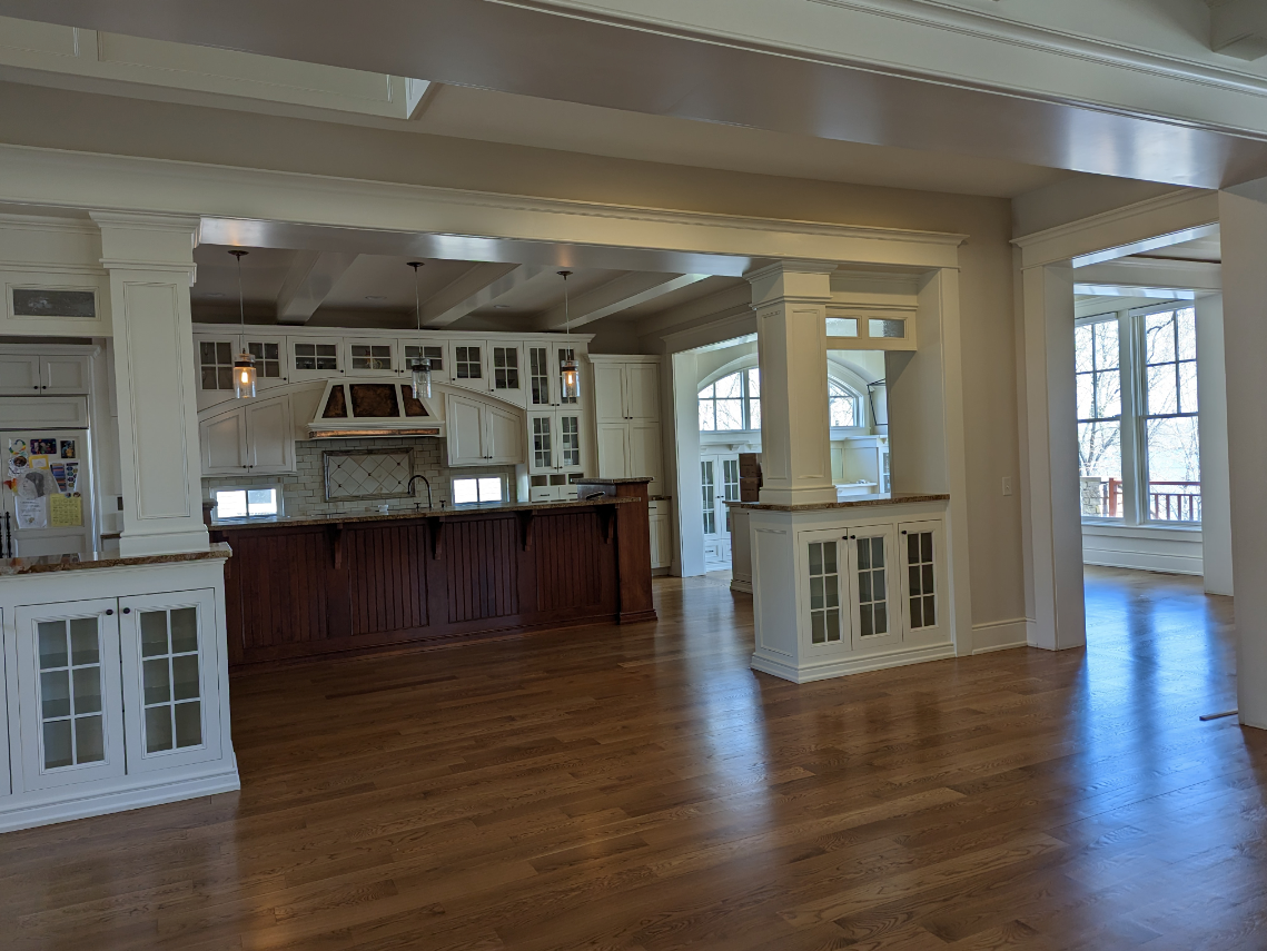 Custom kitchen with coffered ceilings, hardwood floors, and built-in cabinetry restored